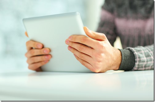 Closeup image of male hands holding tablet computer